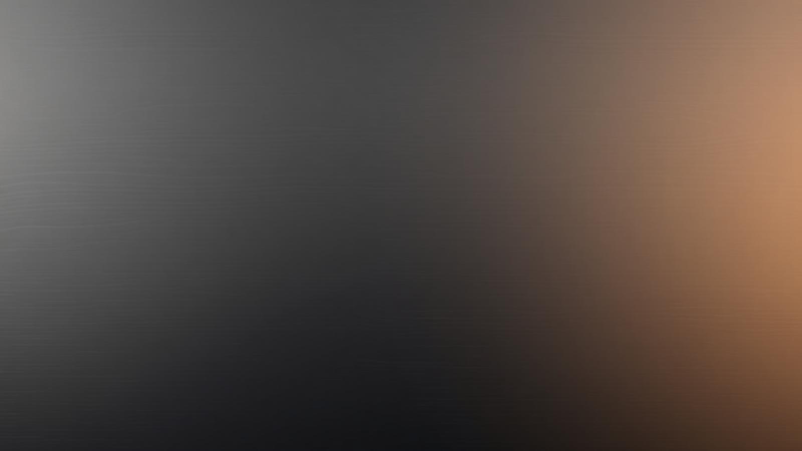 Brushed charcoal and warm metallic surface representing the SYON brand
